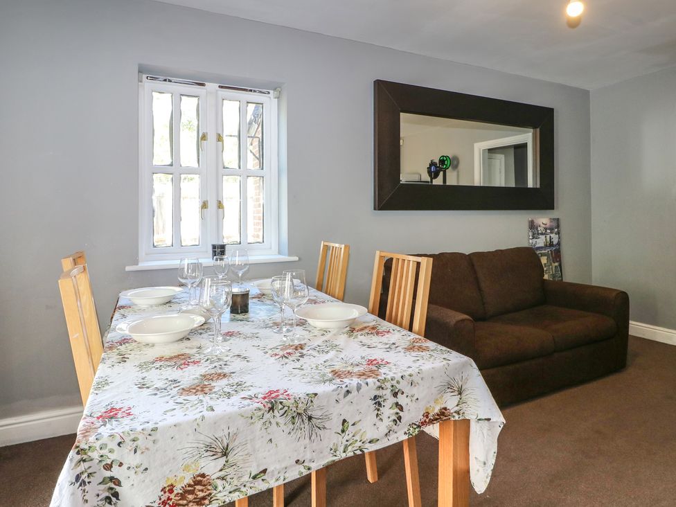 A dining room with a table set for meals at Tiffanys Coach House in Bournemouth