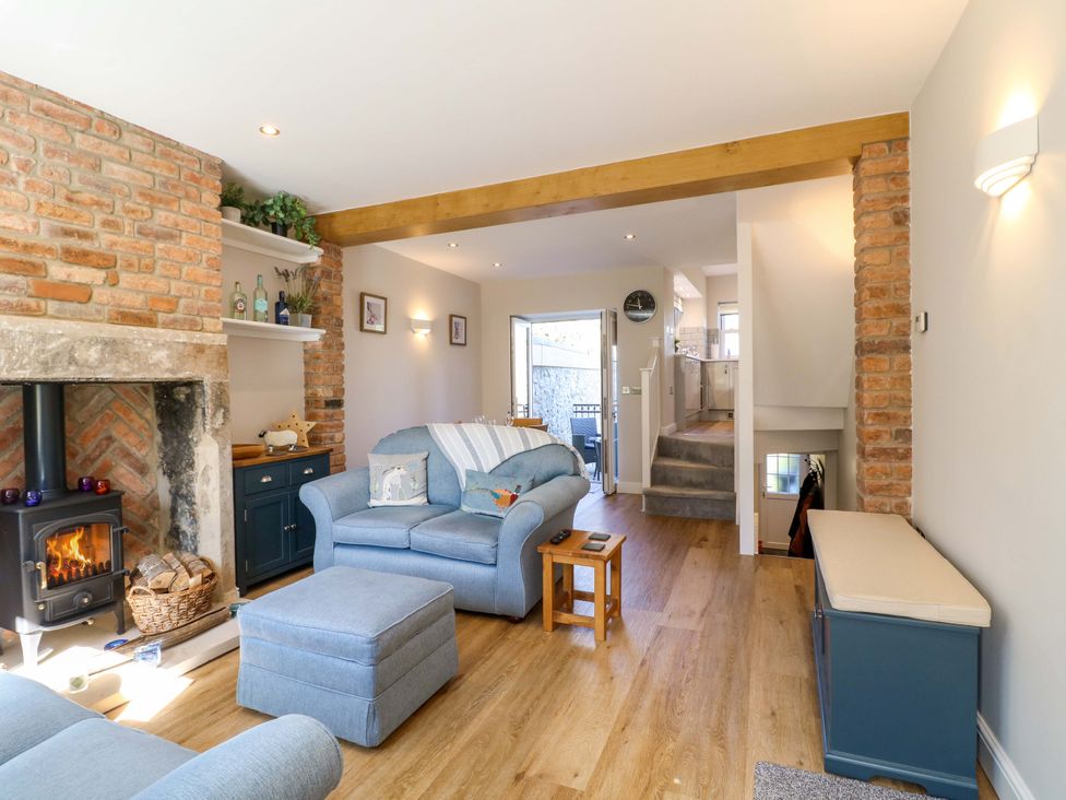 A living room with a fireplace and sofa at 7 Catcliffe Cottages in Bakewell