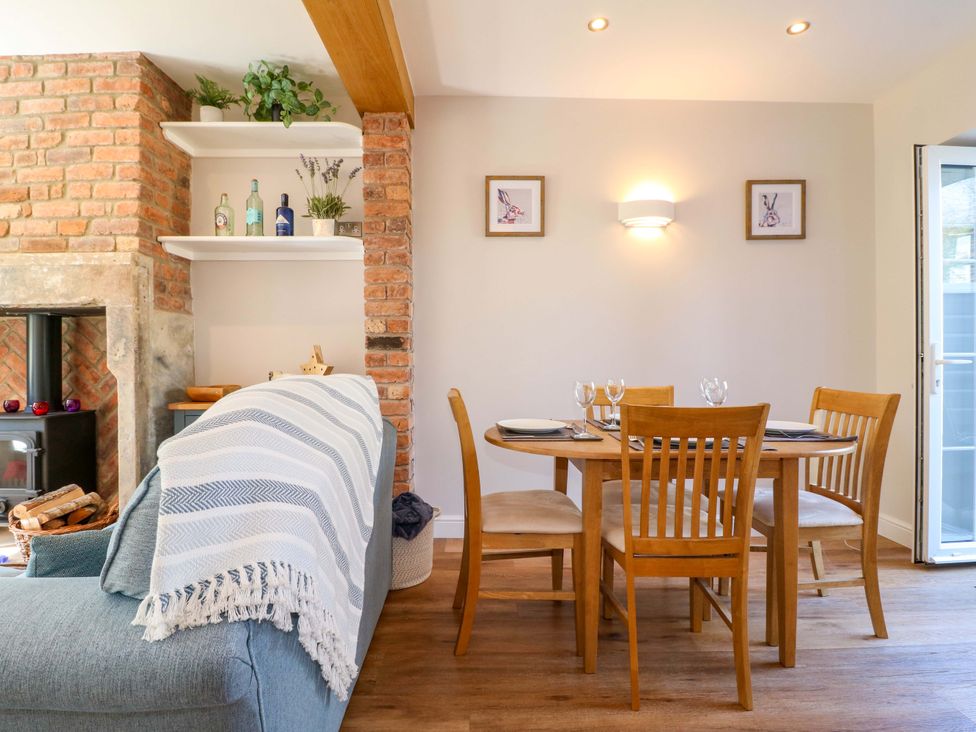 A dining room with a table and chairs at 7 Catcliffe Cottages in Bakewell