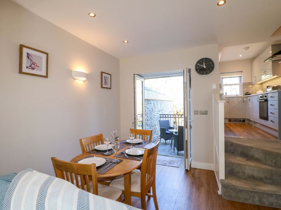A dining room with a table set for a meal at 7 Catcliffe Cottages in Bakewell
