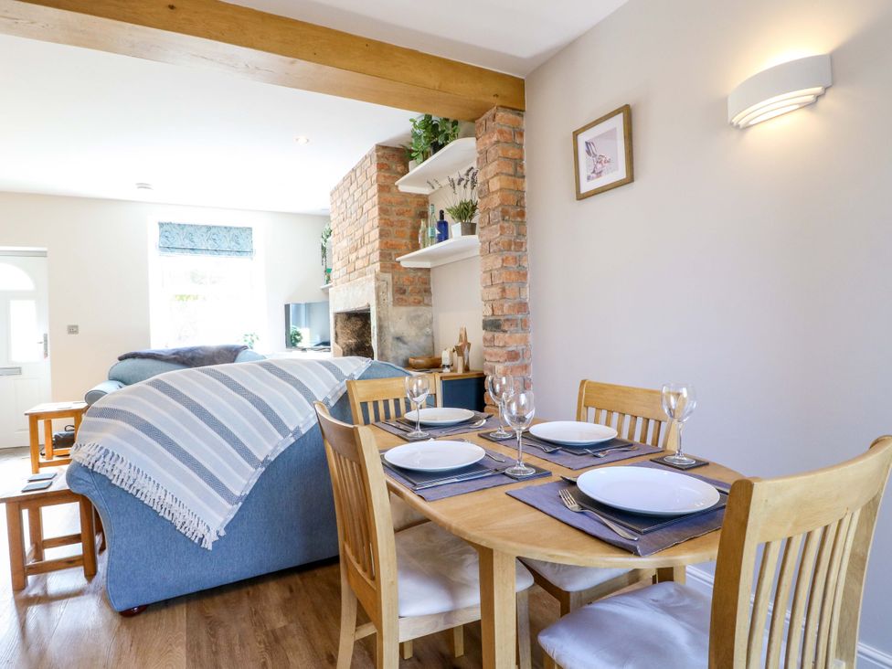 A dining area with a table and chairs at 7 Catcliffe Cottages in Bakewell