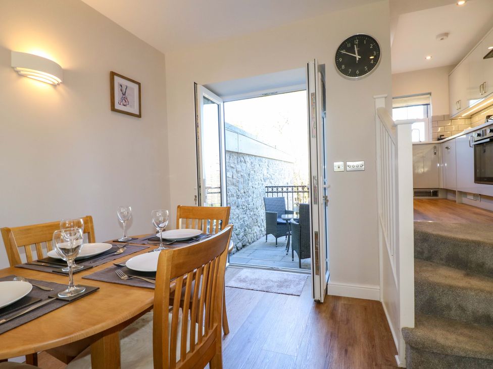 A dining room with a table and chairs at 7 Catcliffe Cottages in Bakewell