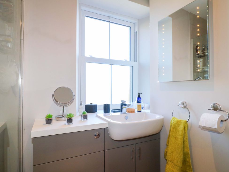 A bathroom with a sink and a mirror at 7 Catcliffe Cottages in Bakewell