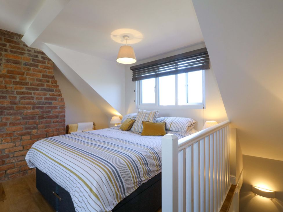 A bedroom with a bed and window at 7 Catcliffe Cottages Bakewell