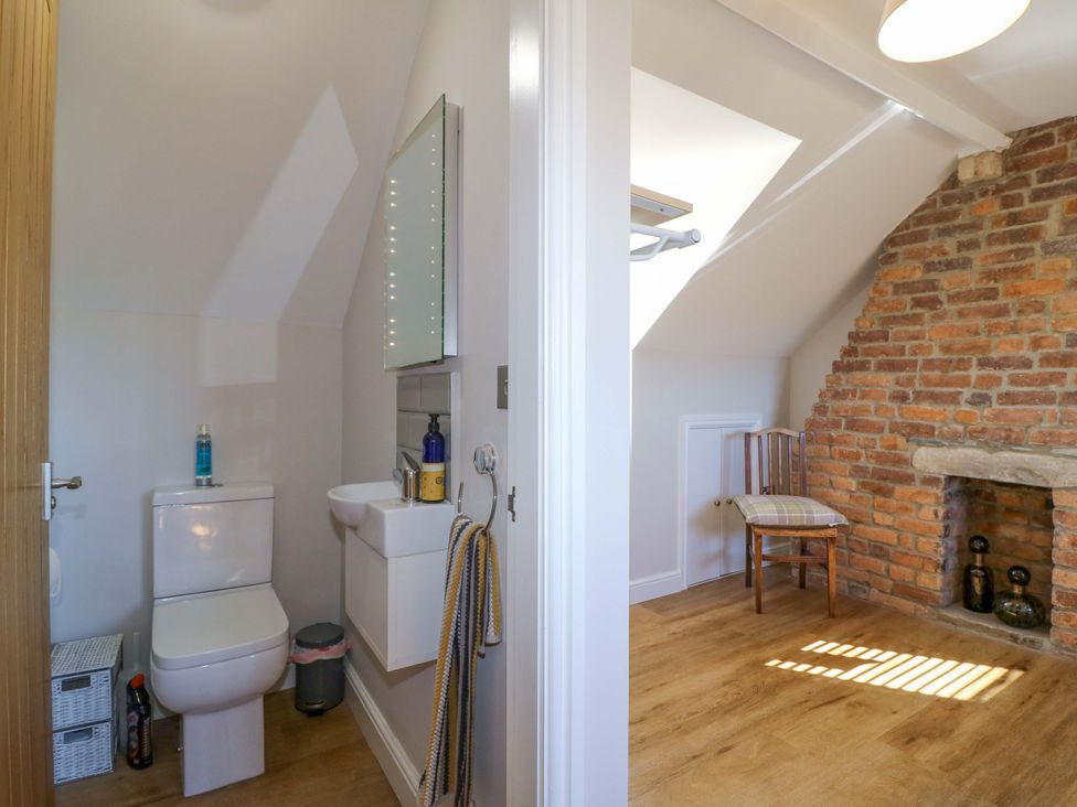 A bathroom with a toilet and sink at 7 Catcliffe Cottages Bakewell