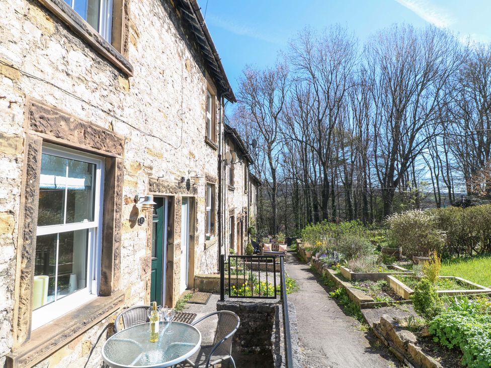 An outdoor area with a stone building and garden at 7 Catcliffe Cottages in Bakewell