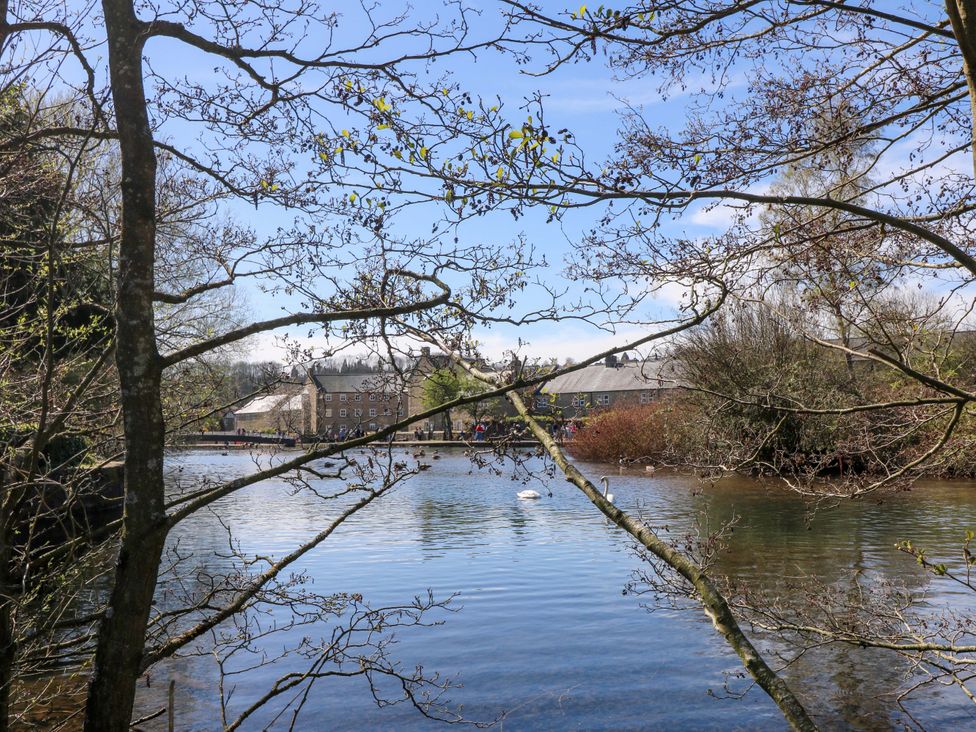 A view of water with trees and buildings in the background at 7 Catcliffe Cottages Bakewell