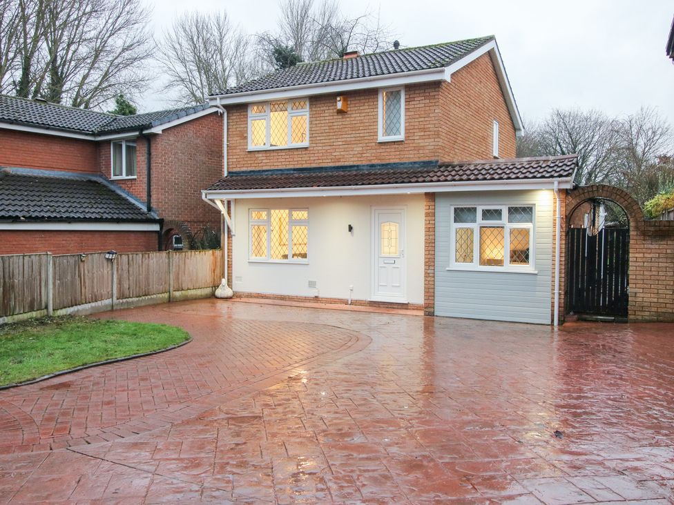 A house with a driveway and fence at 12 Beaufort Close Telford