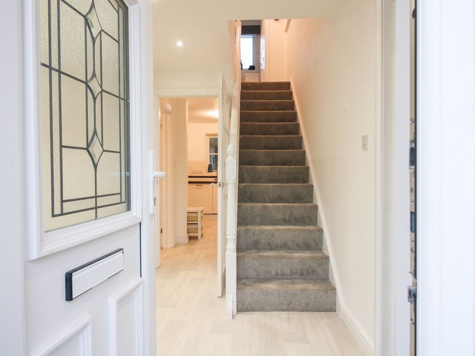 A hallway with a staircase viewed from the entrance at 12 Beaufort Close Telford