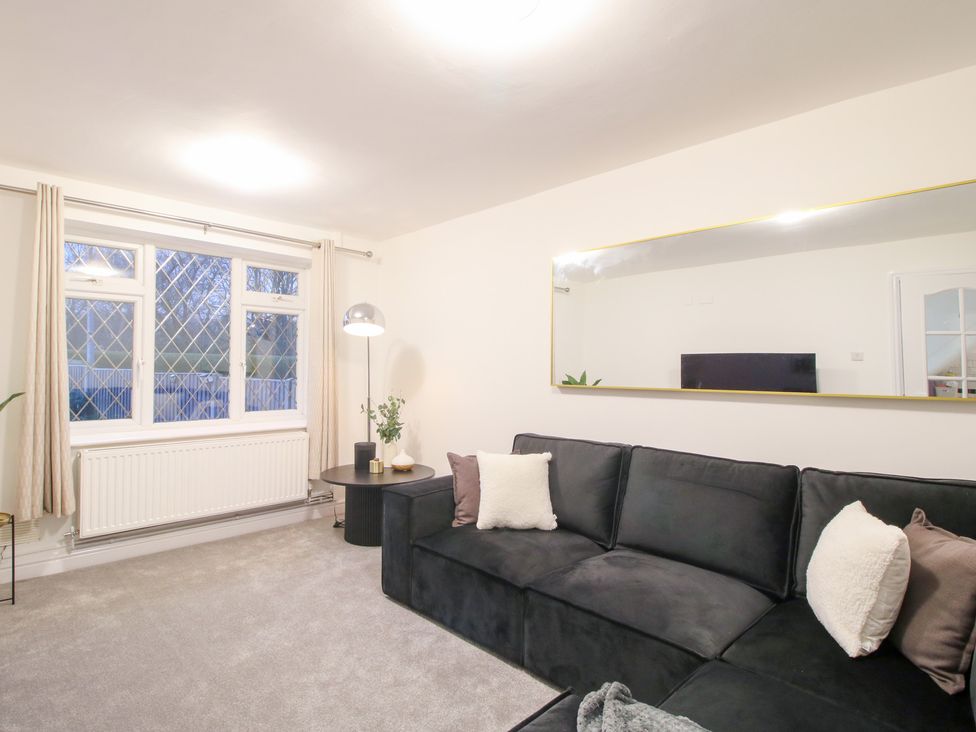 A living room with a sofa and window at 12 Beaufort Close in Telford