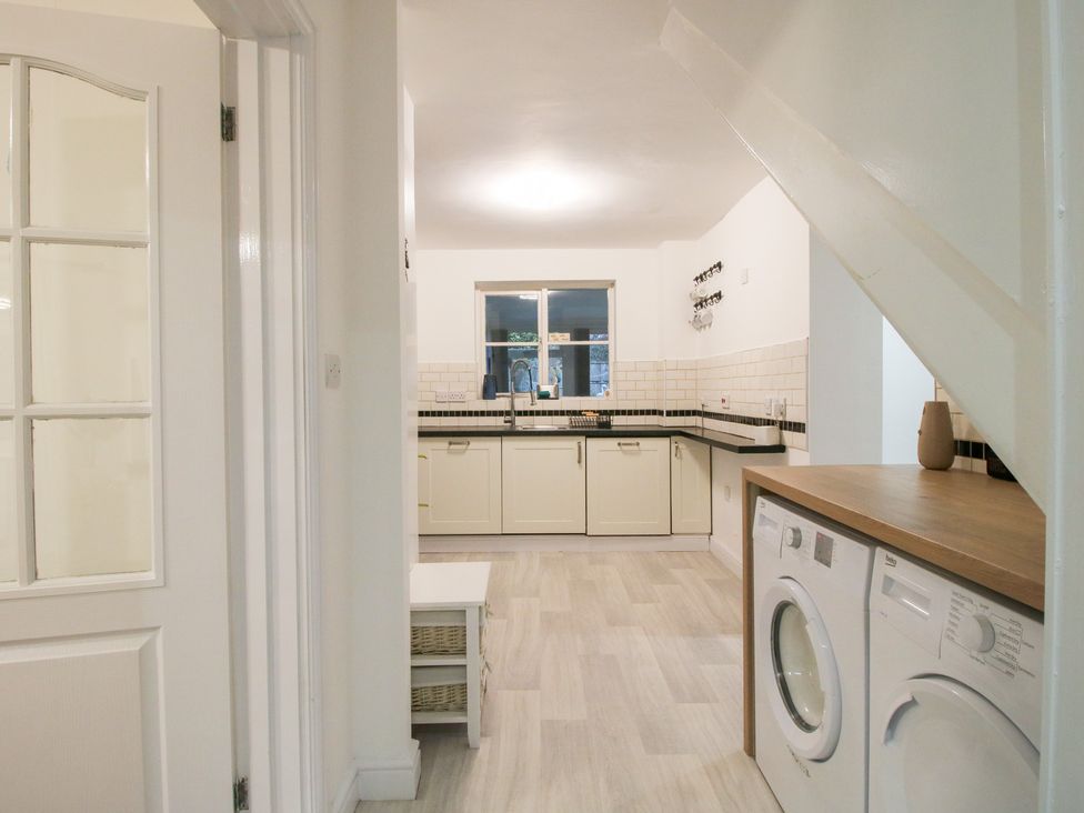 A kitchen with a washing machine and countertop at 12 Beaufort Close Telford