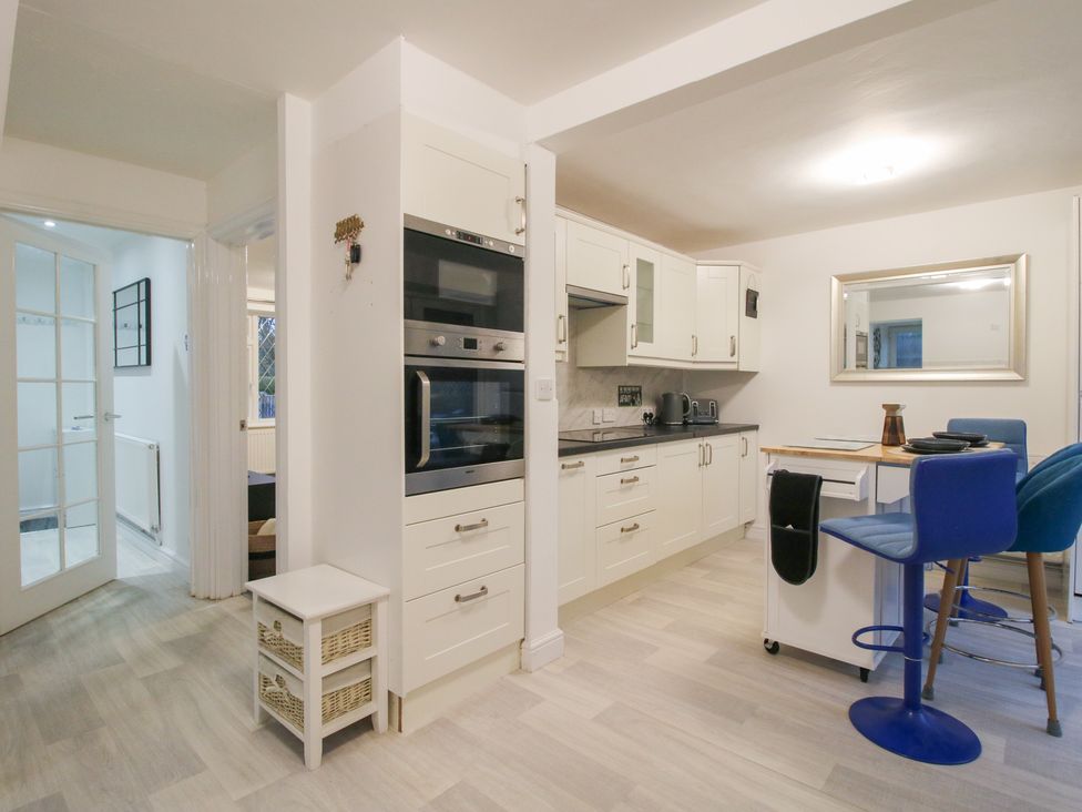 A kitchen with appliances and seating at 12 Beaufort Close, Telford