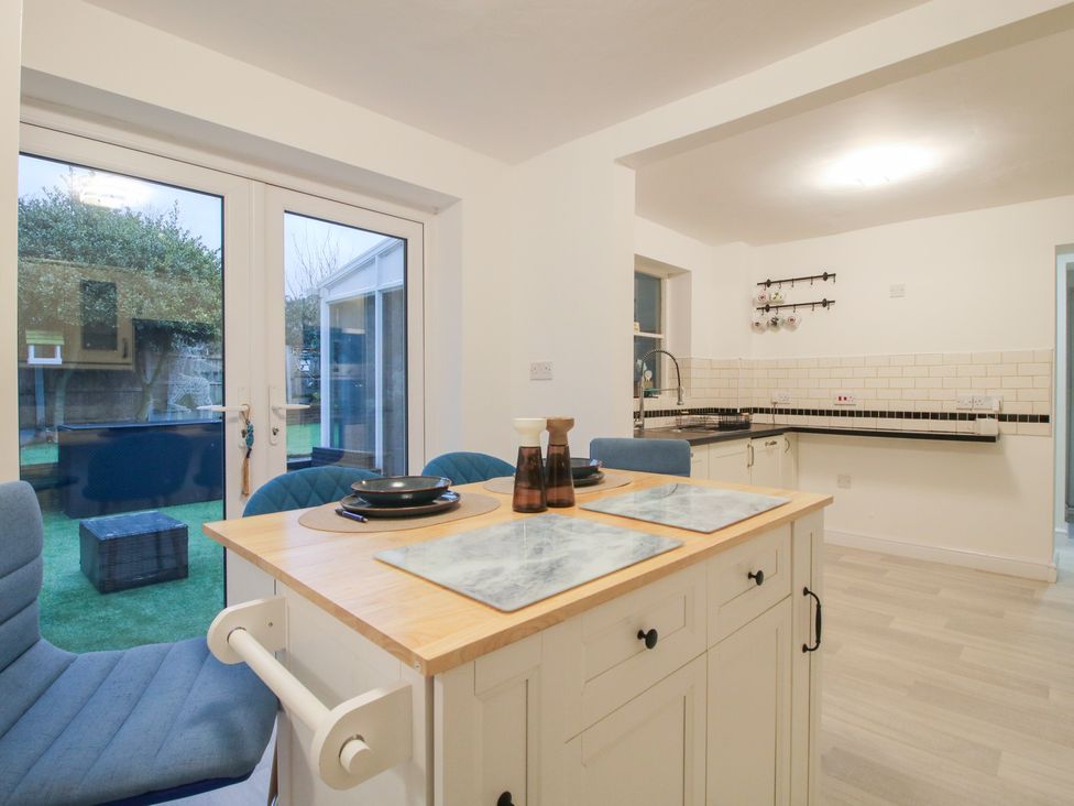 A kitchen with a table and chairs at 12 Beaufort Close in Telford