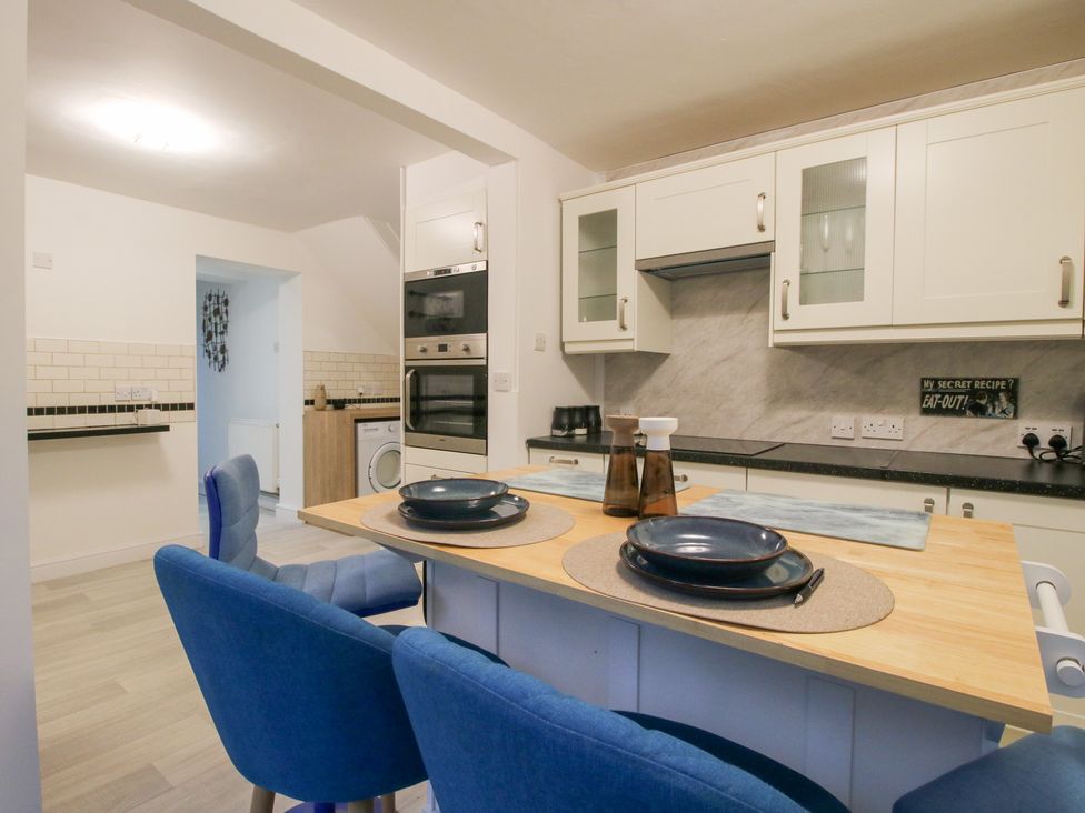 A kitchen with table and chairs at 12 Beaufort Close in Telford