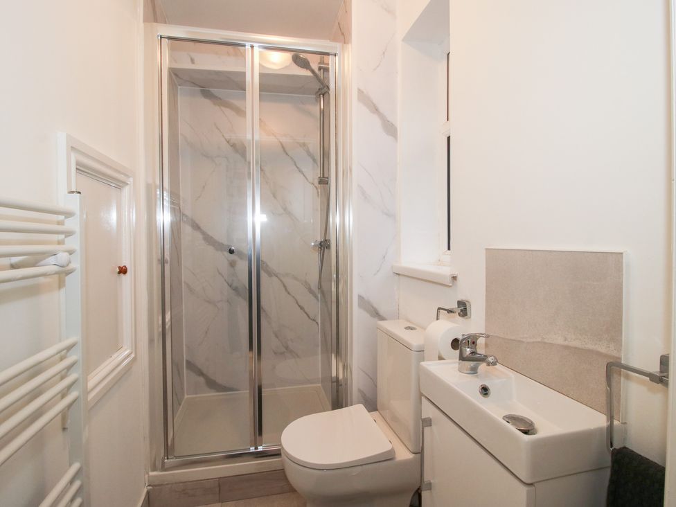 A bathroom with a shower, toilet, and sink at 12 Beaufort Close in Telford