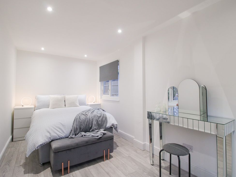 A bedroom with a bed and vanity table at 12 Beaufort Close Telford
