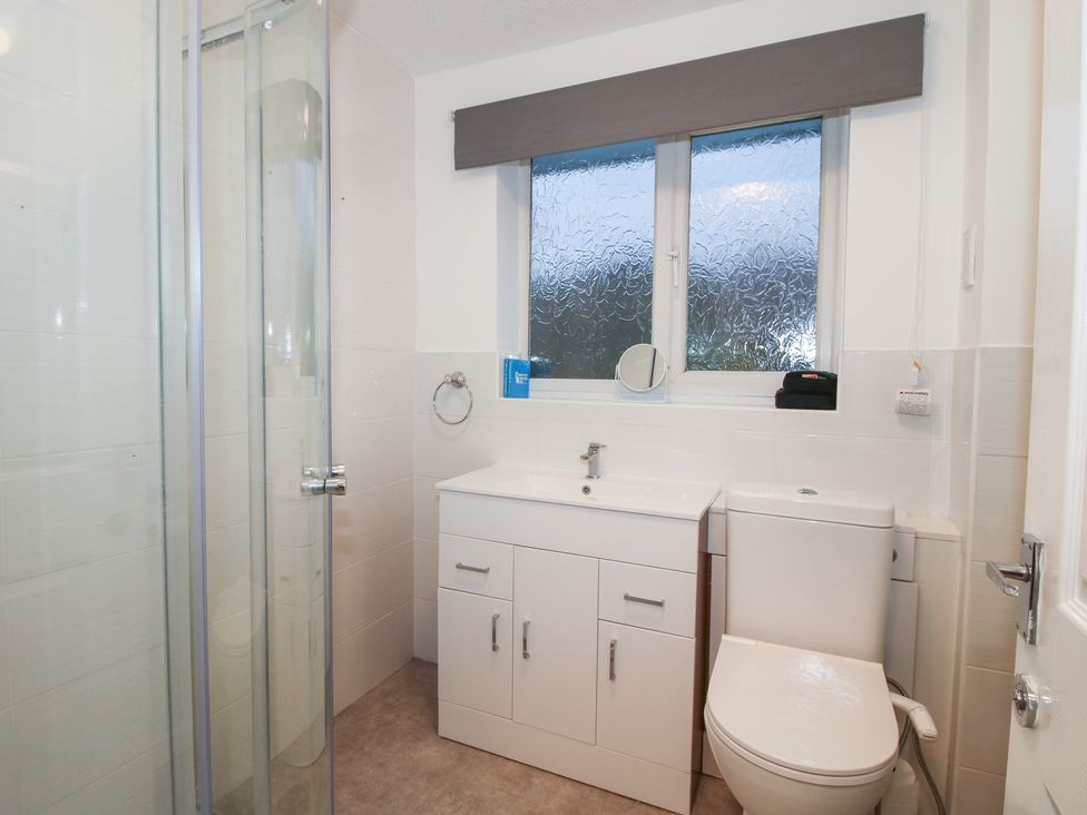 A bathroom with a shower and sink at 12 Beaufort Close Telford
