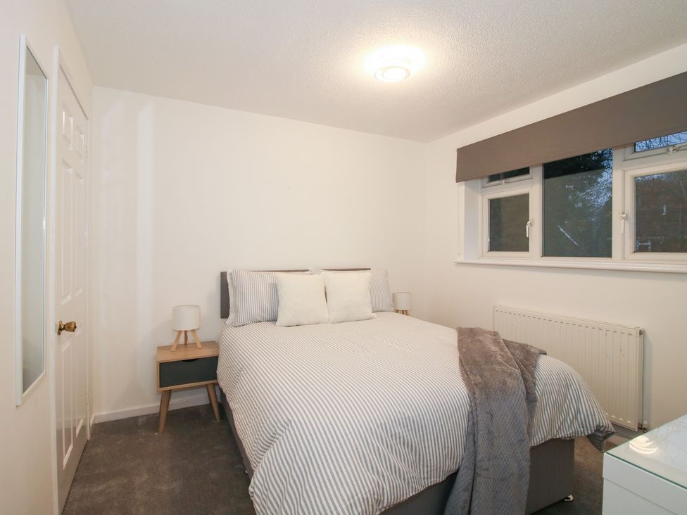 A bedroom with a bed and bedside table at 12 Beaufort Close in Telford