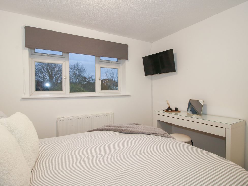 A bedroom with a bed and desk at 12 Beaufort Close Telford