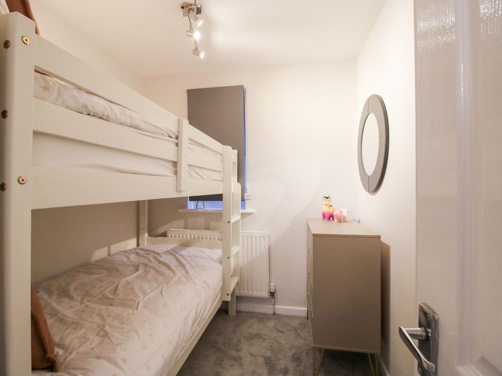A bedroom with bunk beds and a cabinet at 12 Beaufort Close in Telford