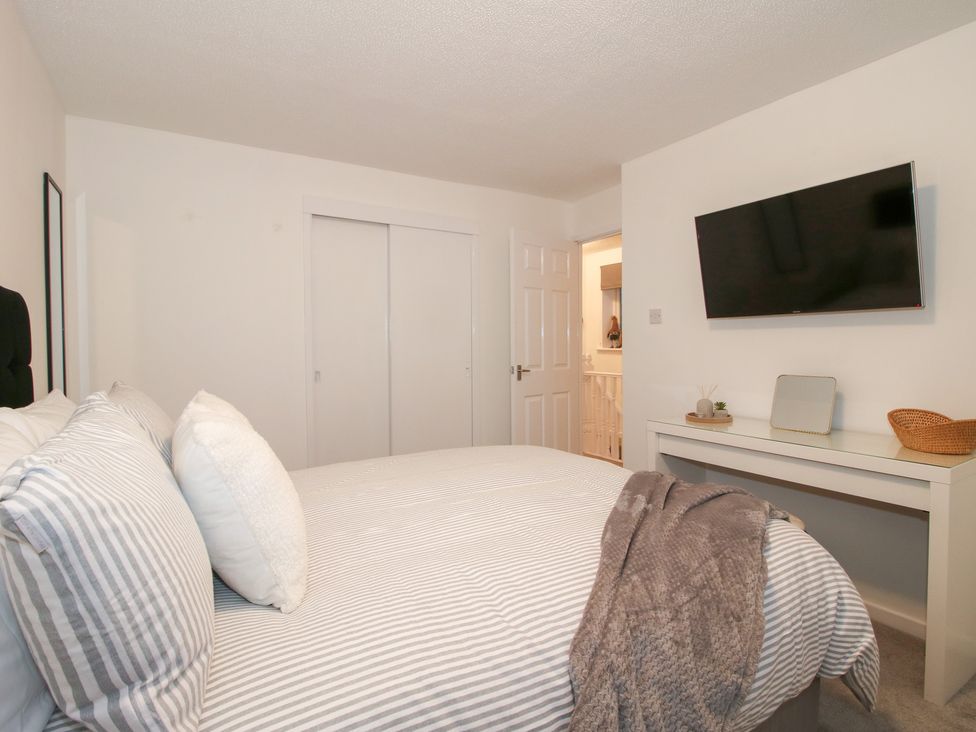 A bedroom with a bed and television at 12 Beaufort Close in Telford