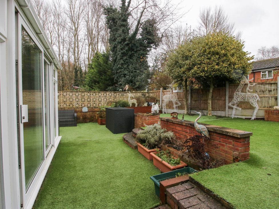 A garden with planters and decorative figures at 12 Beaufort Close in Telford