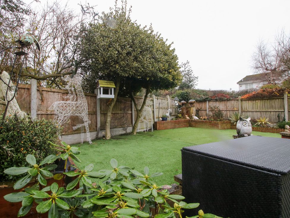 A garden with artificial grass, trees, and decorative figures at 12 Beaufort Close Telford