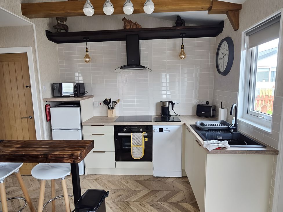 A kitchen with appliances and a work surface at 38A in Bridlington