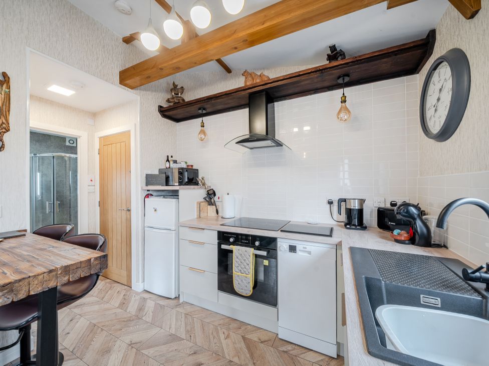 A kitchen with appliances and wooden features at 38A in Bridlington