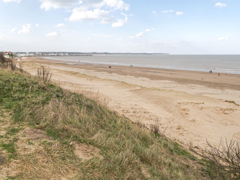 A beach with sea and people in the distance at 38A in Bridlington