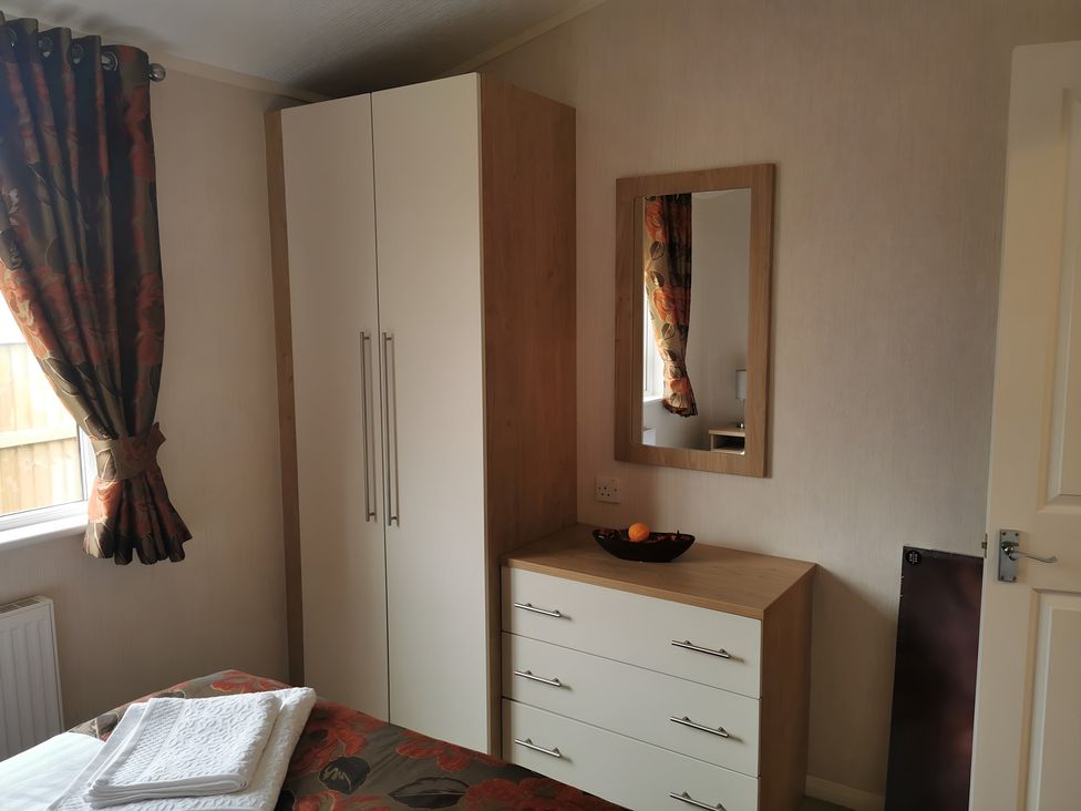 A bedroom with a wardrobe and dresser at 311 Bridlington