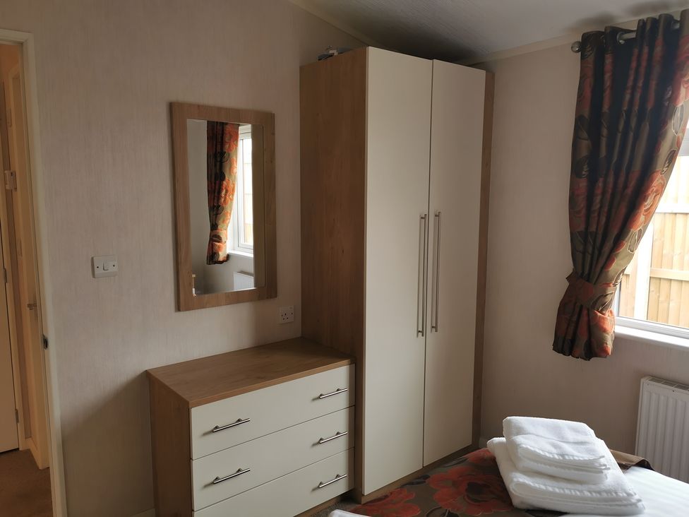 A bedroom with a wardrobe and mirror at 311 Bridlington