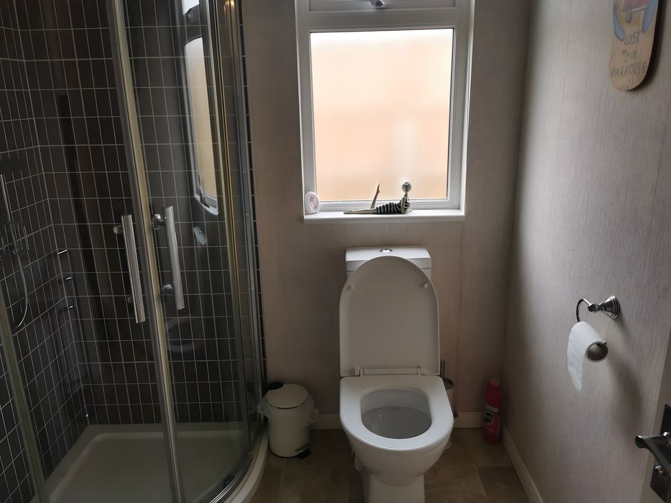 A bathroom featuring a shower and toilet at 311 Bridlington