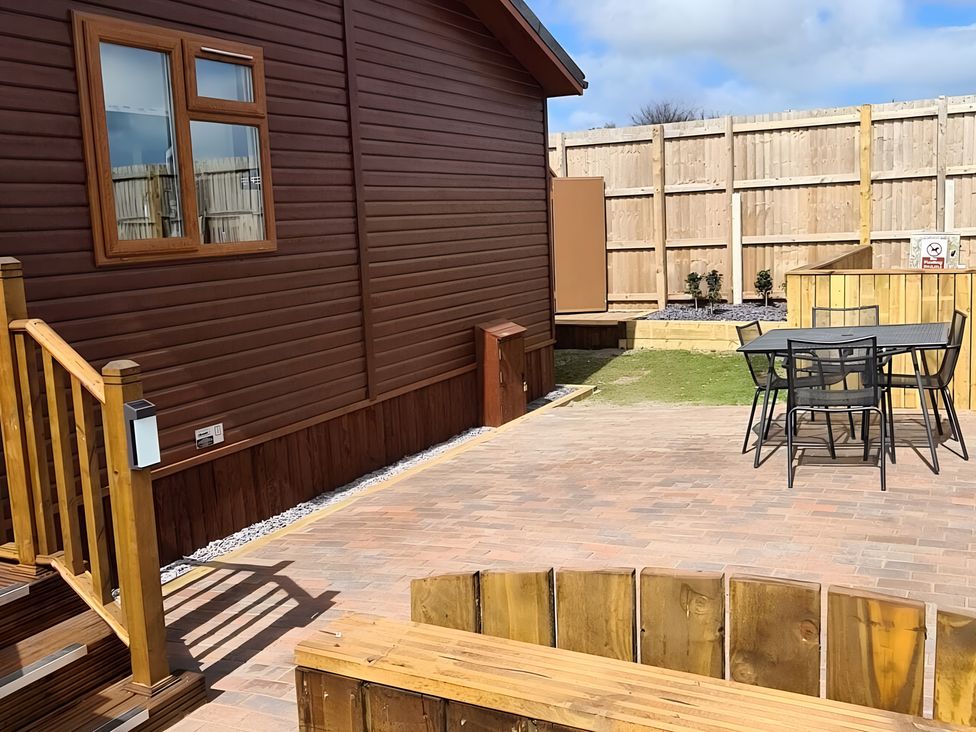 An outdoor area with a table and chairs near a house at 311 Bridlington