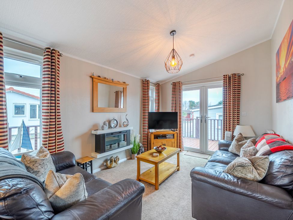 A living room with a television and sofa at 311 Bridlington