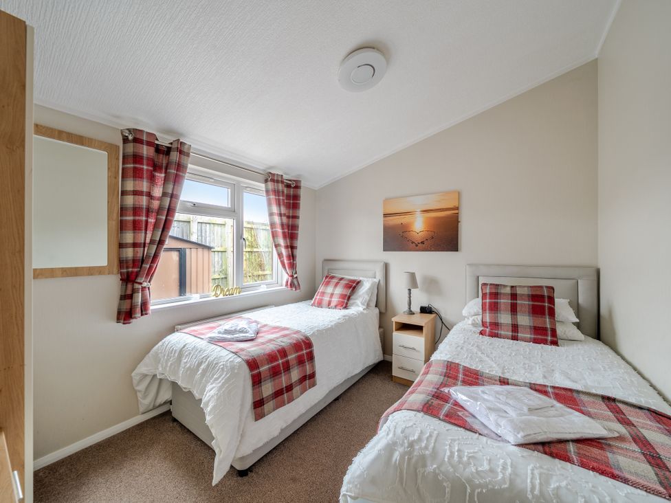 A bedroom with two beds and a nightstand at 311 in Bridlington