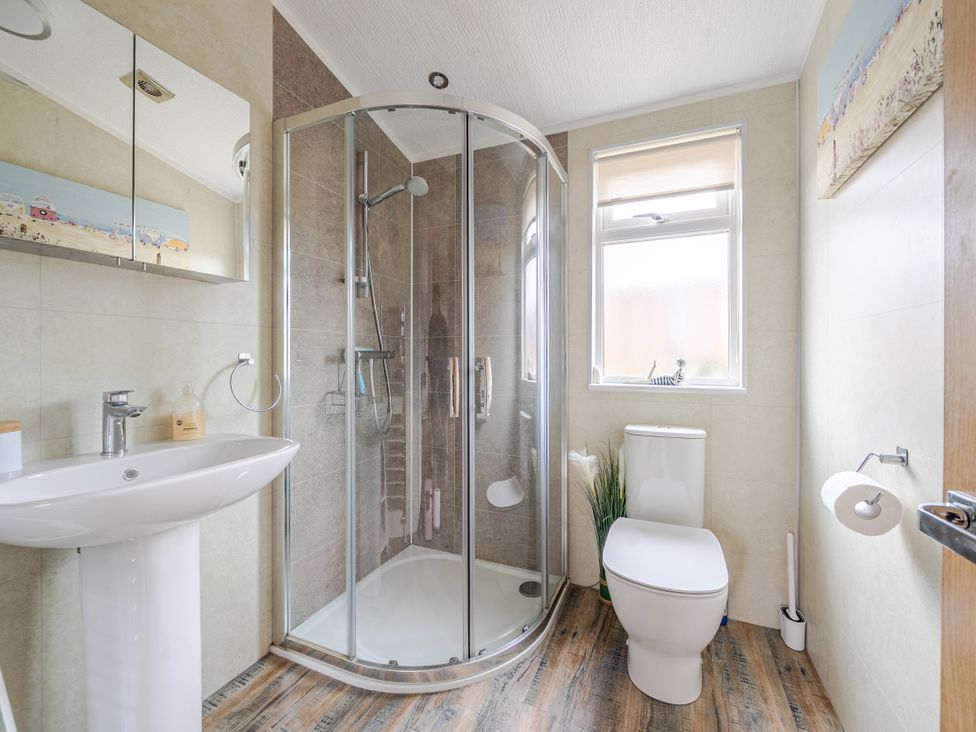 A bathroom with a shower, toilet, and sink at 311 in Bridlington