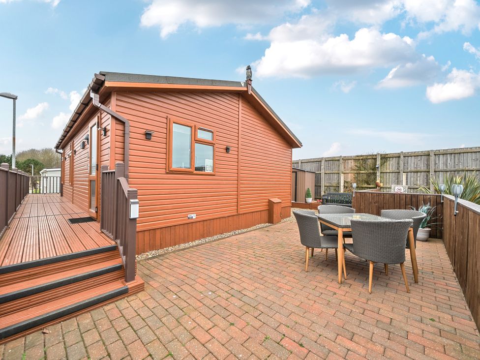 An outdoor area with a wooden house and dining set at 311 Bridlington