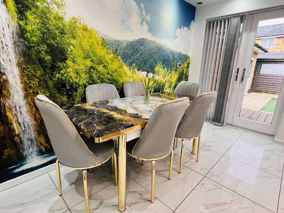 A dining room with a table and chairs at Fairclough Close in Northolt