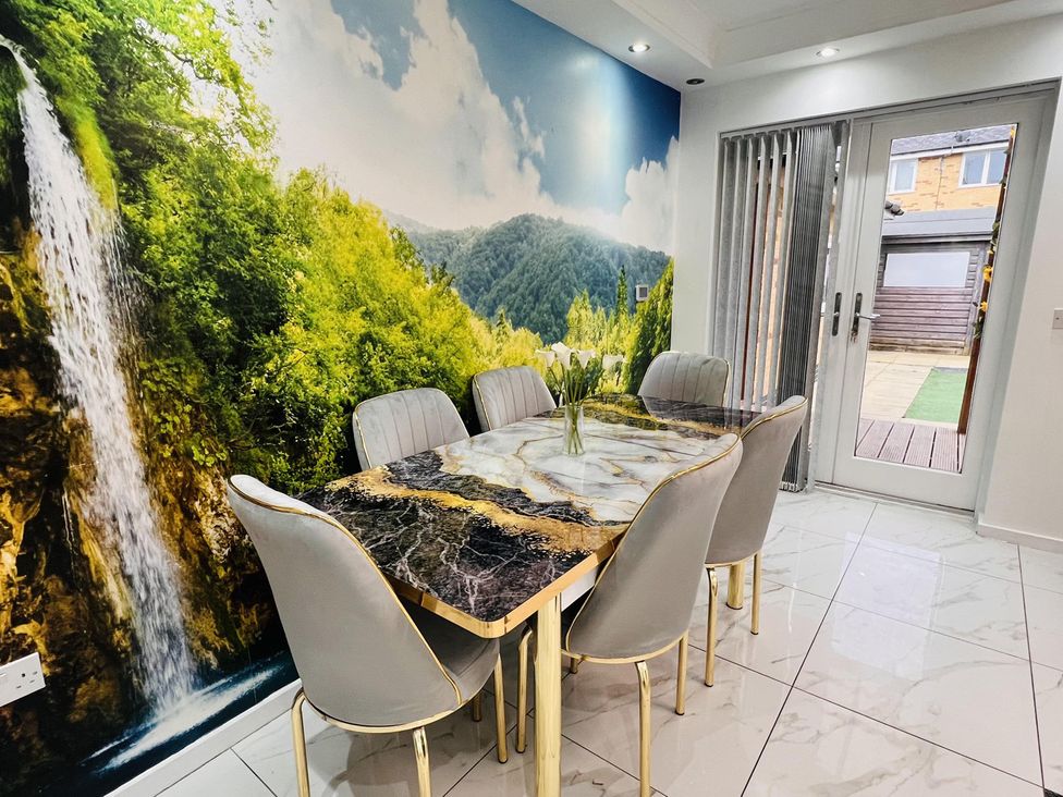 A dining room with a table and chairs at Fairclough Close in Northolt