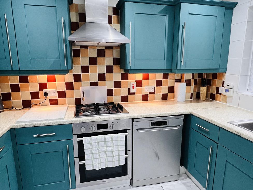 A kitchen with a gas stove and dishwasher at Fairclough Close in Northolt