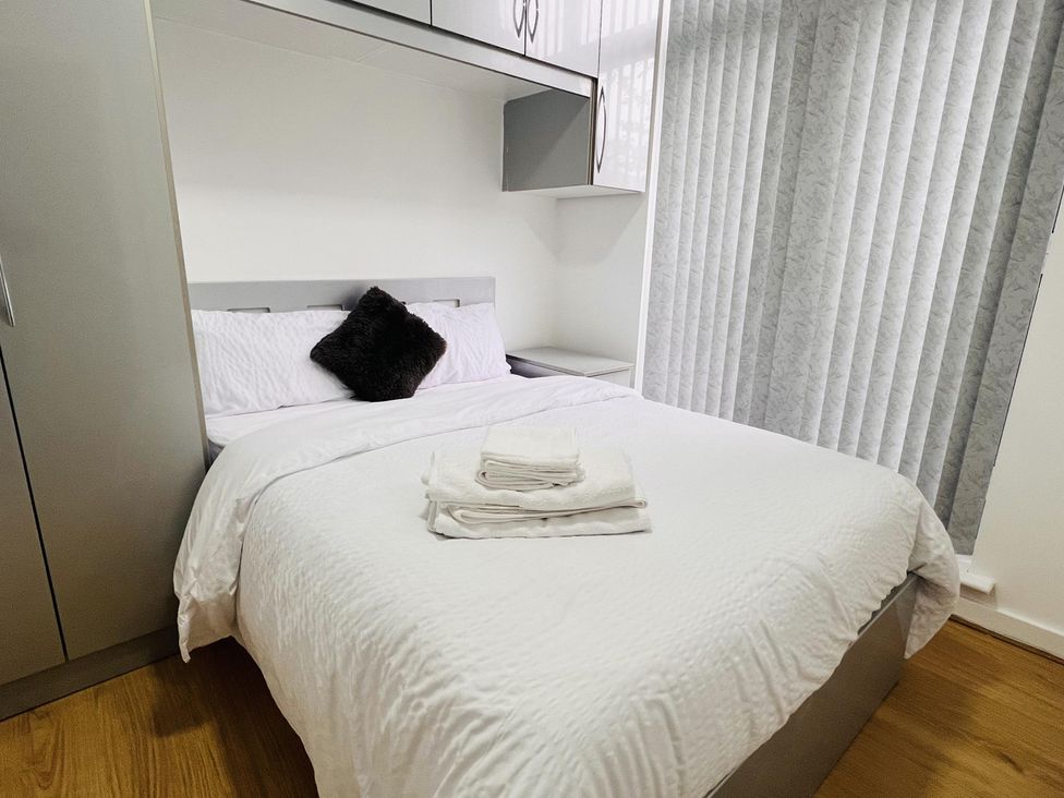 A bedroom with a bed and wardrobe at Fairclough Close Northolt