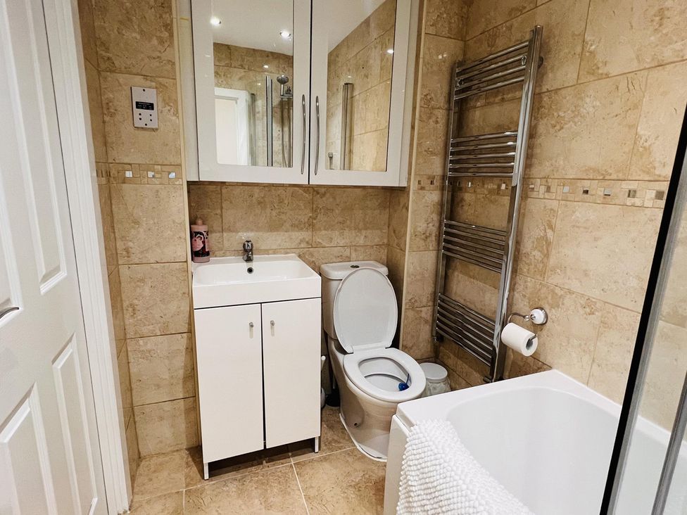 A bathroom with a sink and toilet at Fairclough Close in Northolt
