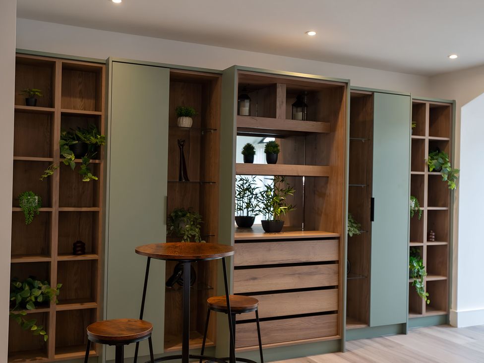 A living room with shelves and plants at The Galloway in Morpeth