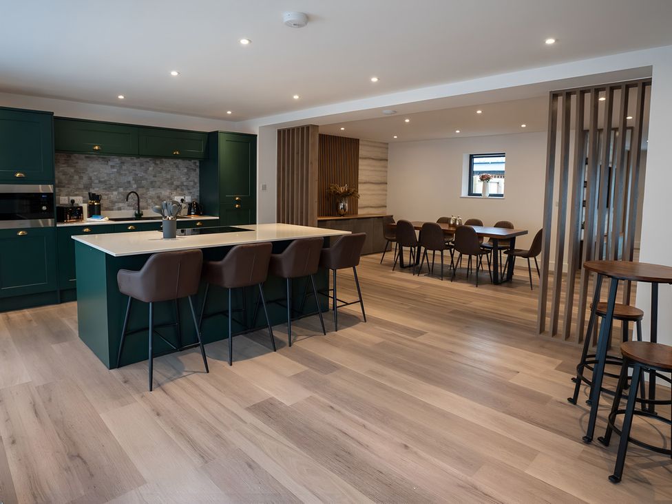 A kitchen with an island and dining area at The Galloway in Morpeth