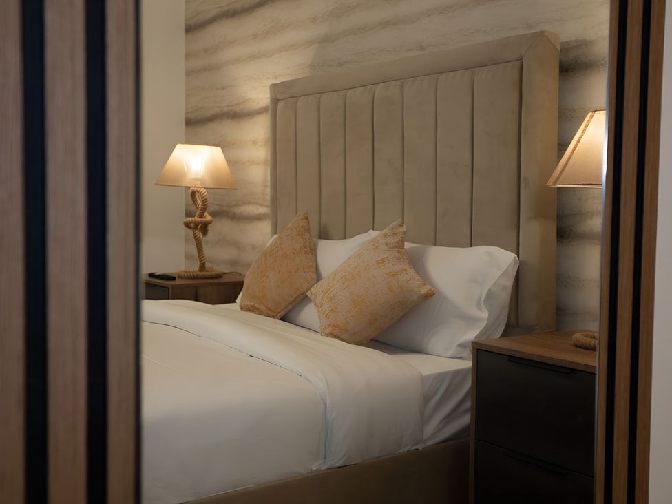 A bedroom with a bed and lamp at The Galloway in Morpeth