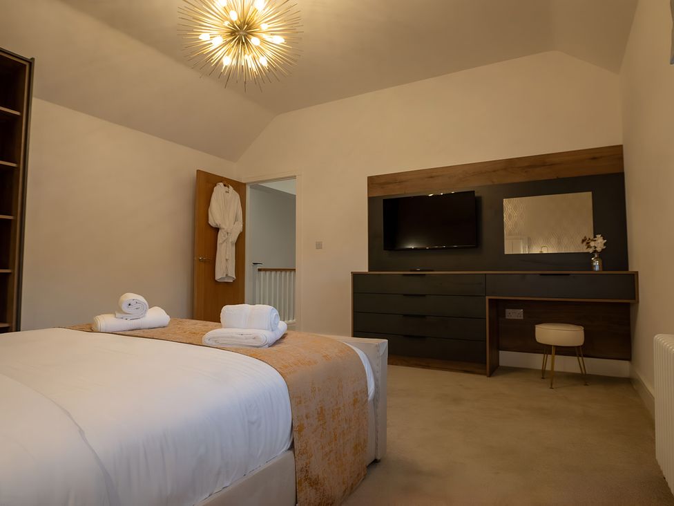 A bedroom with a bed and television at The Galloway in Morpeth