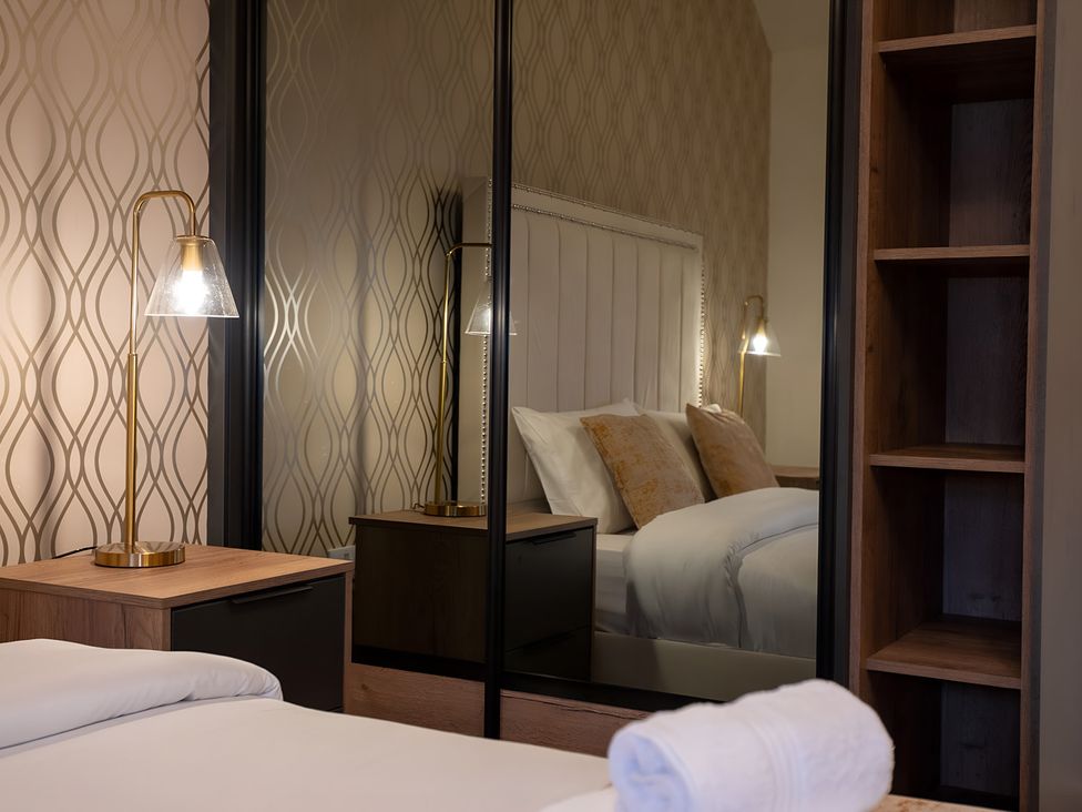 A bedroom with a bed and lamp at The Galloway in Morpeth