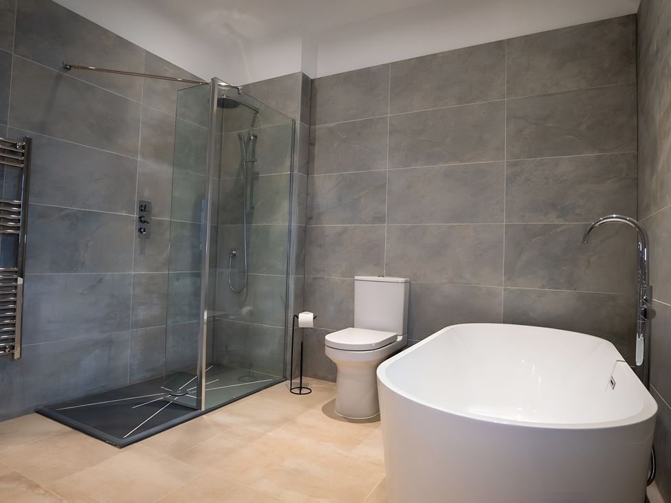 A bathroom with a bathtub and shower at The Galloway in Morpeth