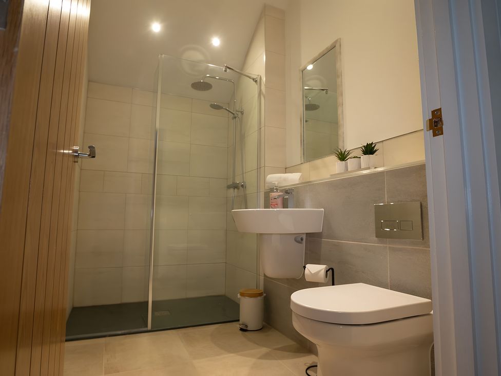 A bathroom with a shower, sink, and toilet at The Galloway in Morpeth
